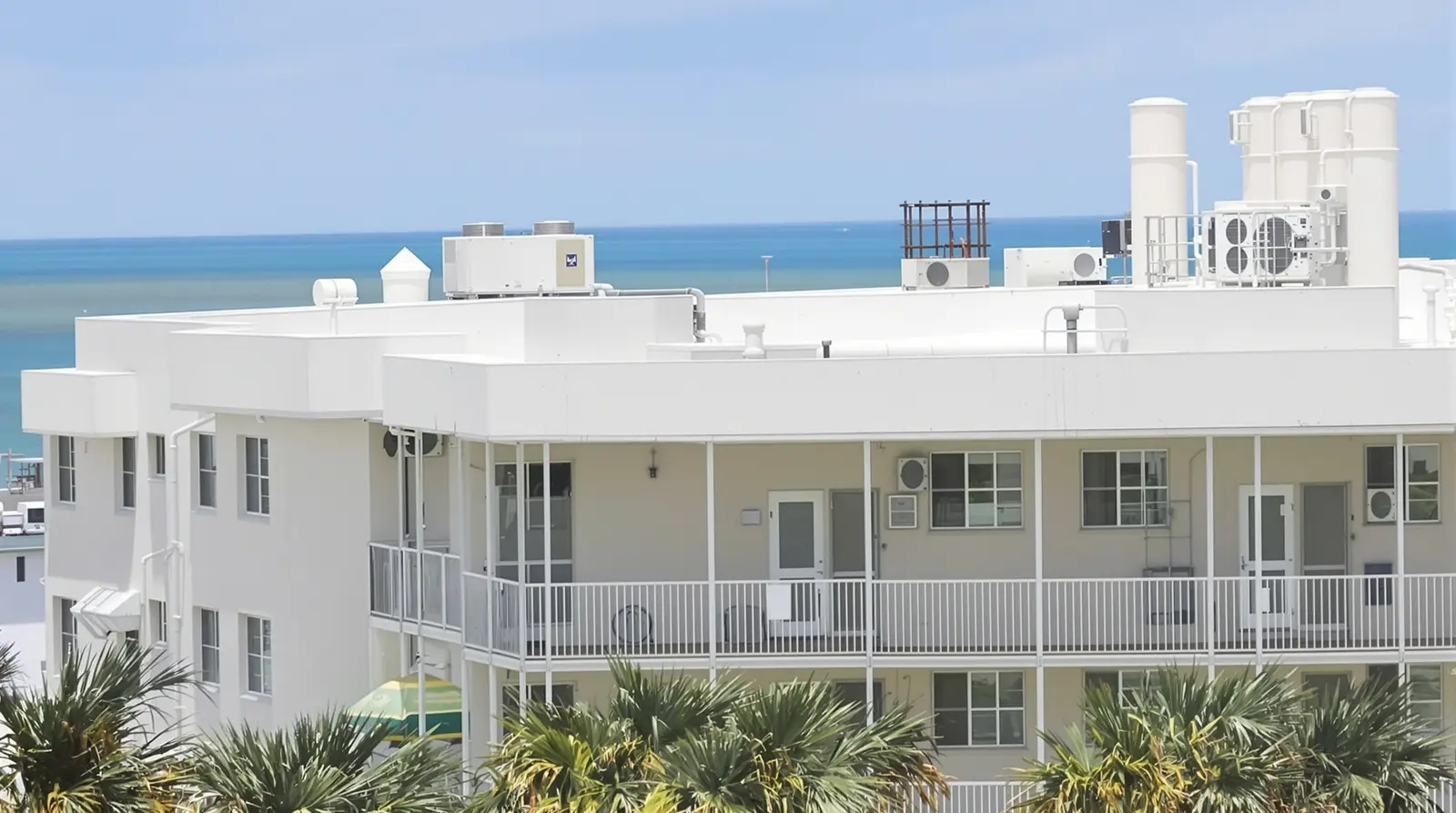Hotel building with flat roof sections on the Gulf Coast showing multi-story commercial roofing
